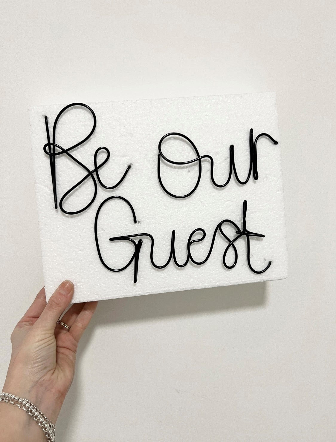 'Be Our Guest' wire sign