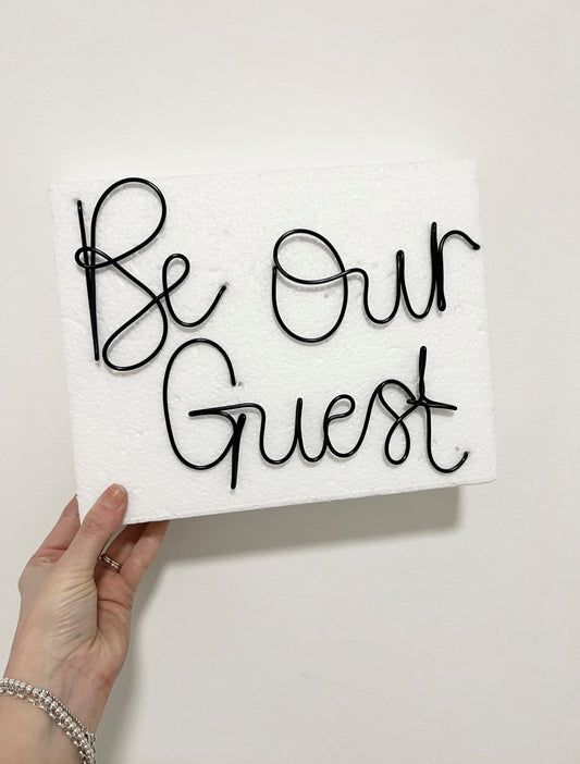 'Be Our Guest' wire sign