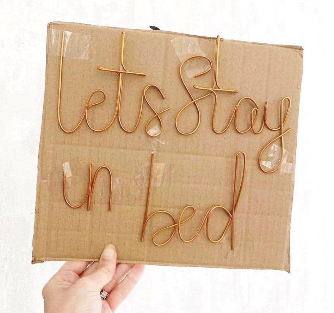 'Lets stay in bed' wire sign