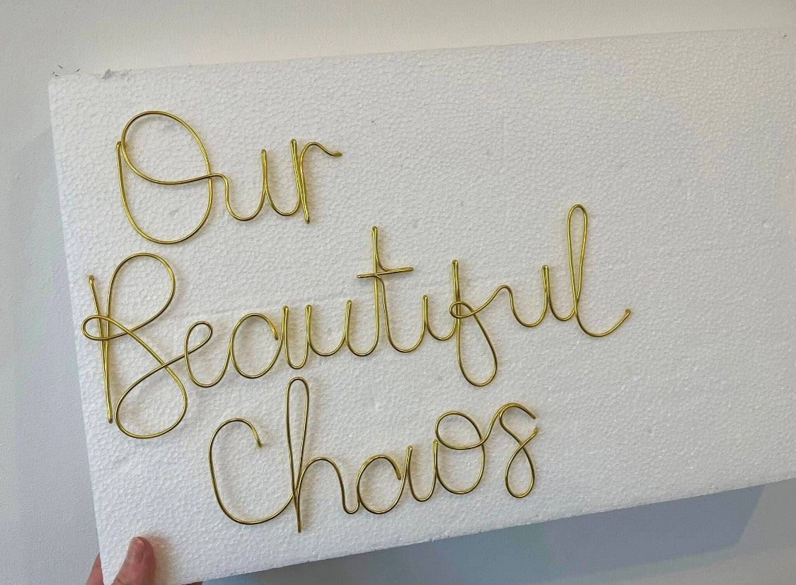 'Our Beautiful Chaos' wire sign
